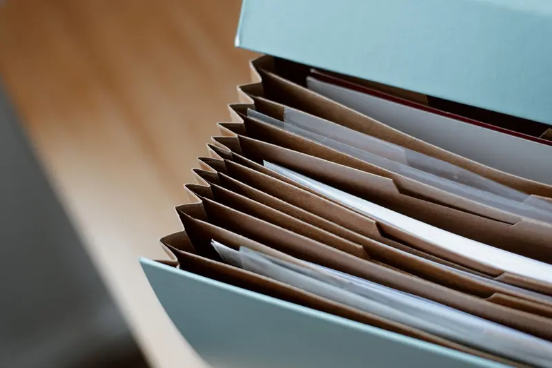 Accordion file folders holding organized documents in compartments