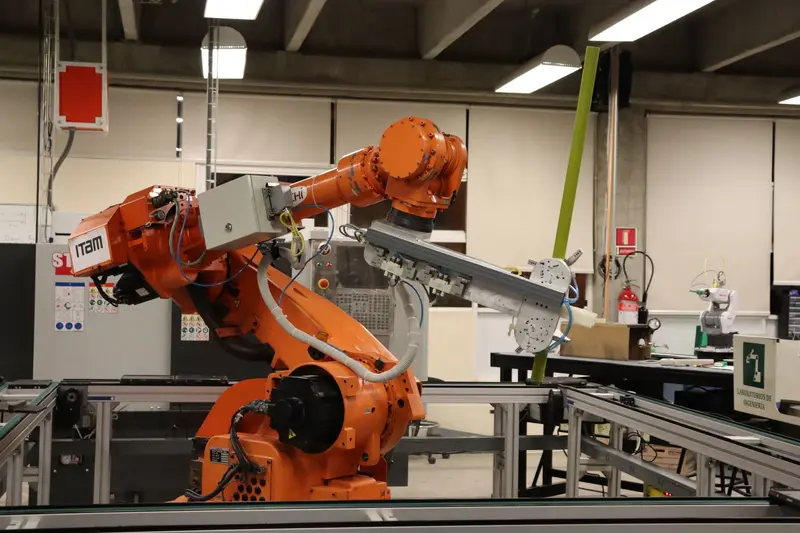 Orange industrial robotic arm on a production line