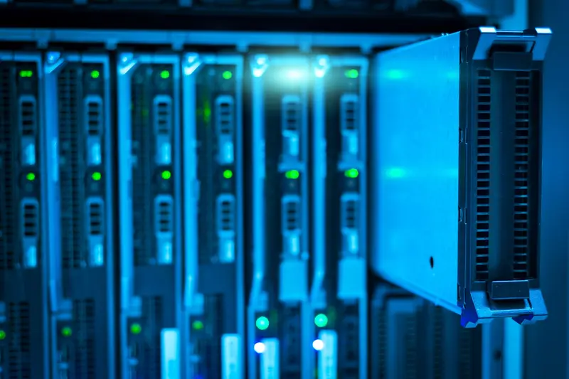 Rows of servers lit in blue inside a data center